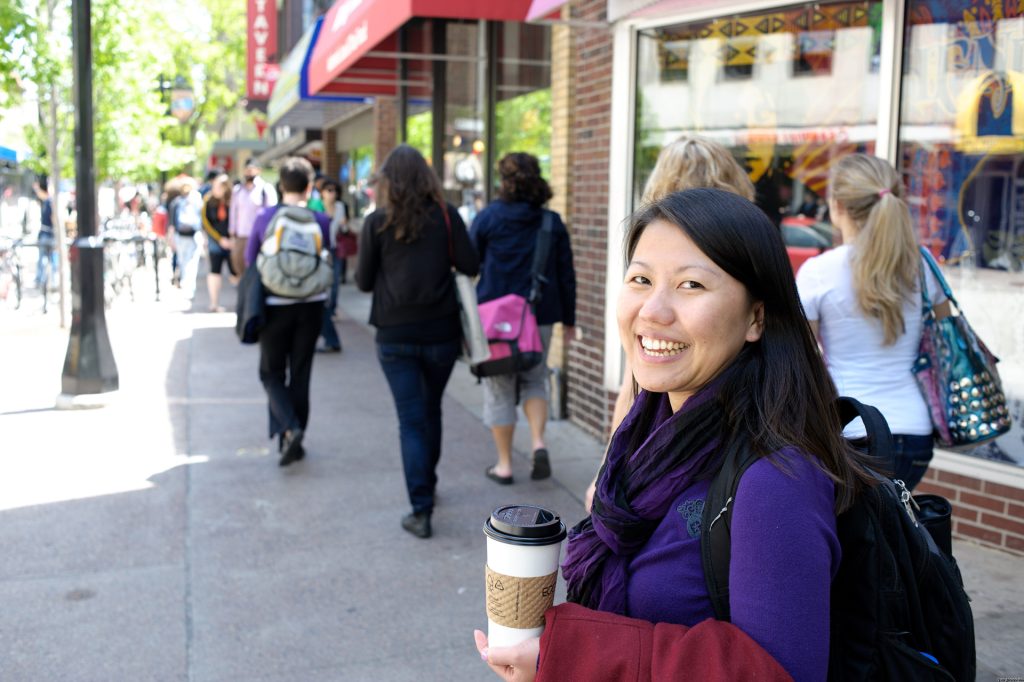 student holding coffee on state st