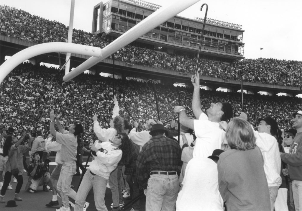 A group of students throw their canes over the field goal in a chaotic moment in 1955.