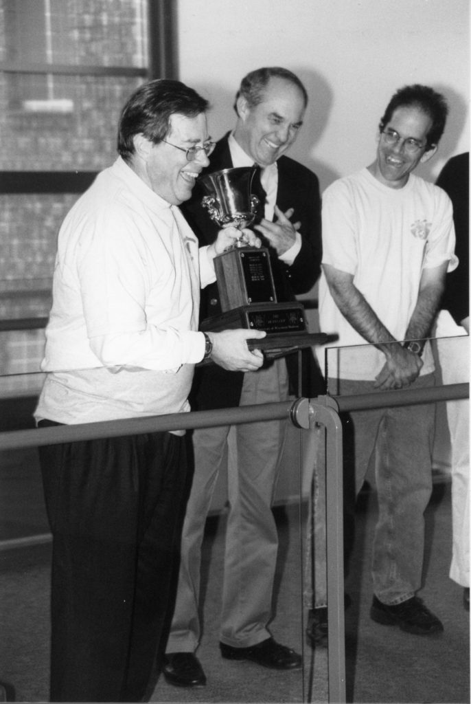 Dean Ken Davis accepts Dean's Cup trophy from School of Medicine