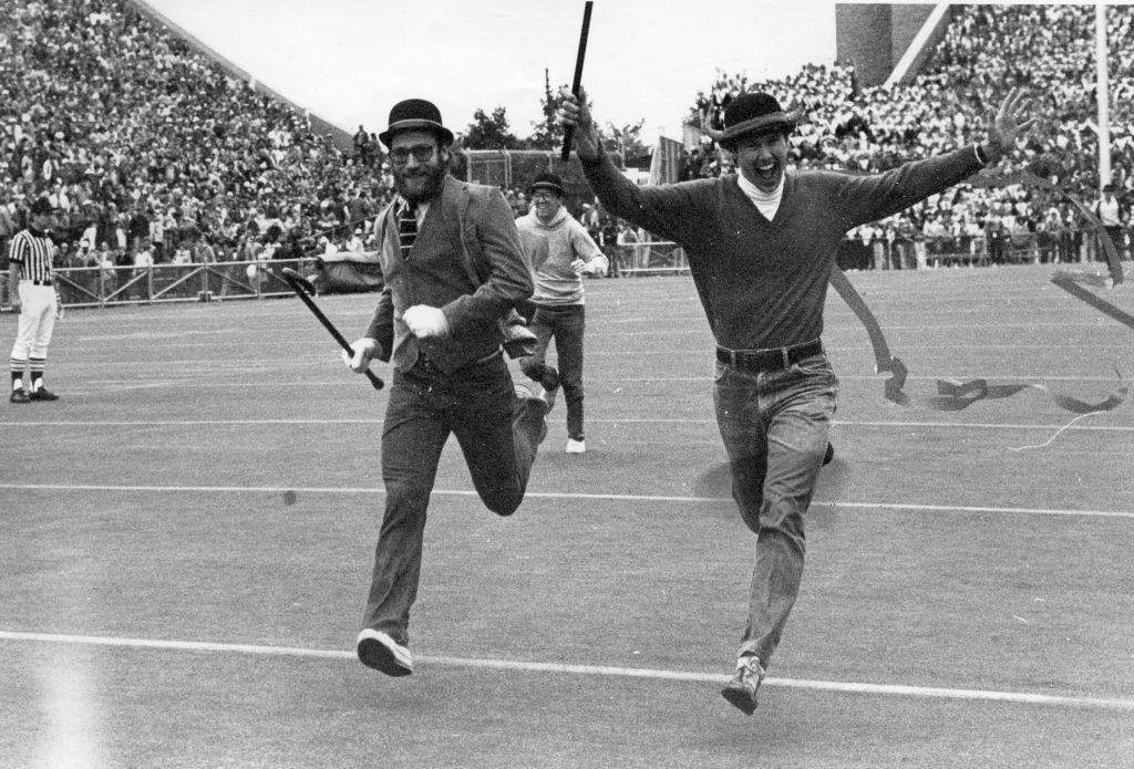 Student running across the Camp Randall field in 1981.