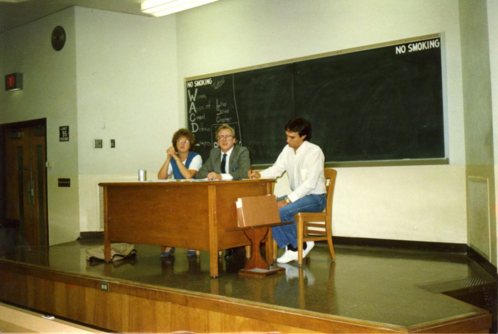 people at a desk on a stag