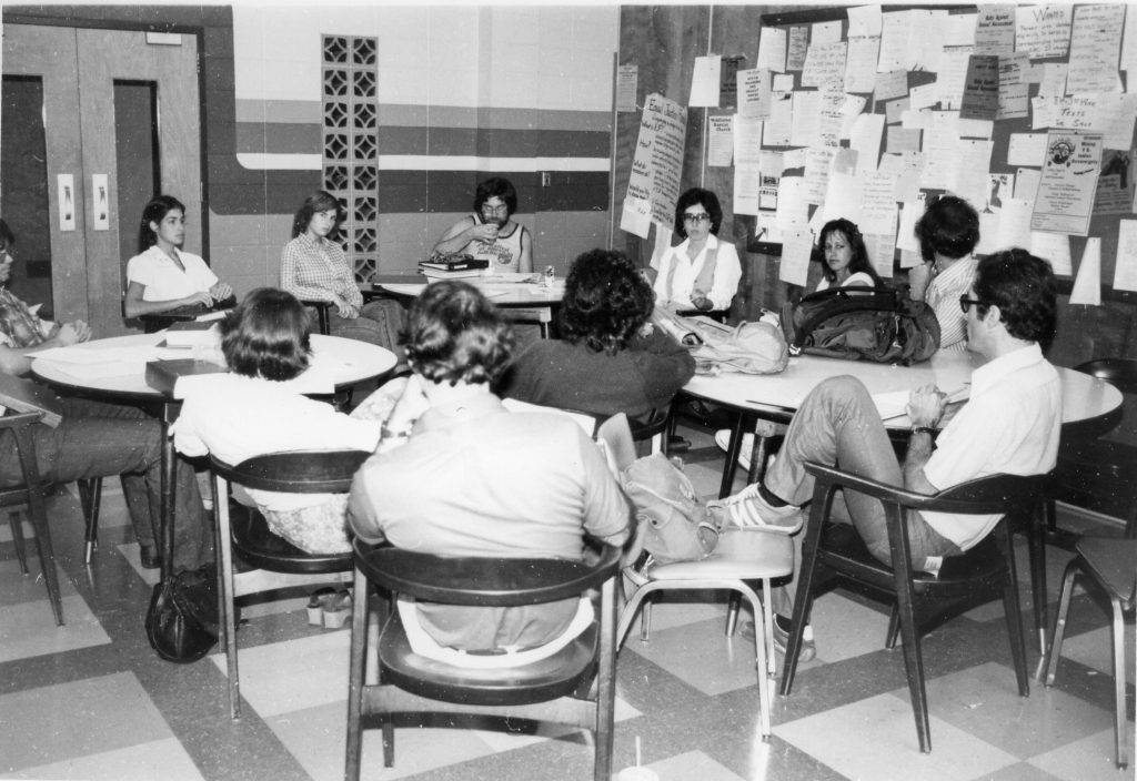 students at desks in a meeting
