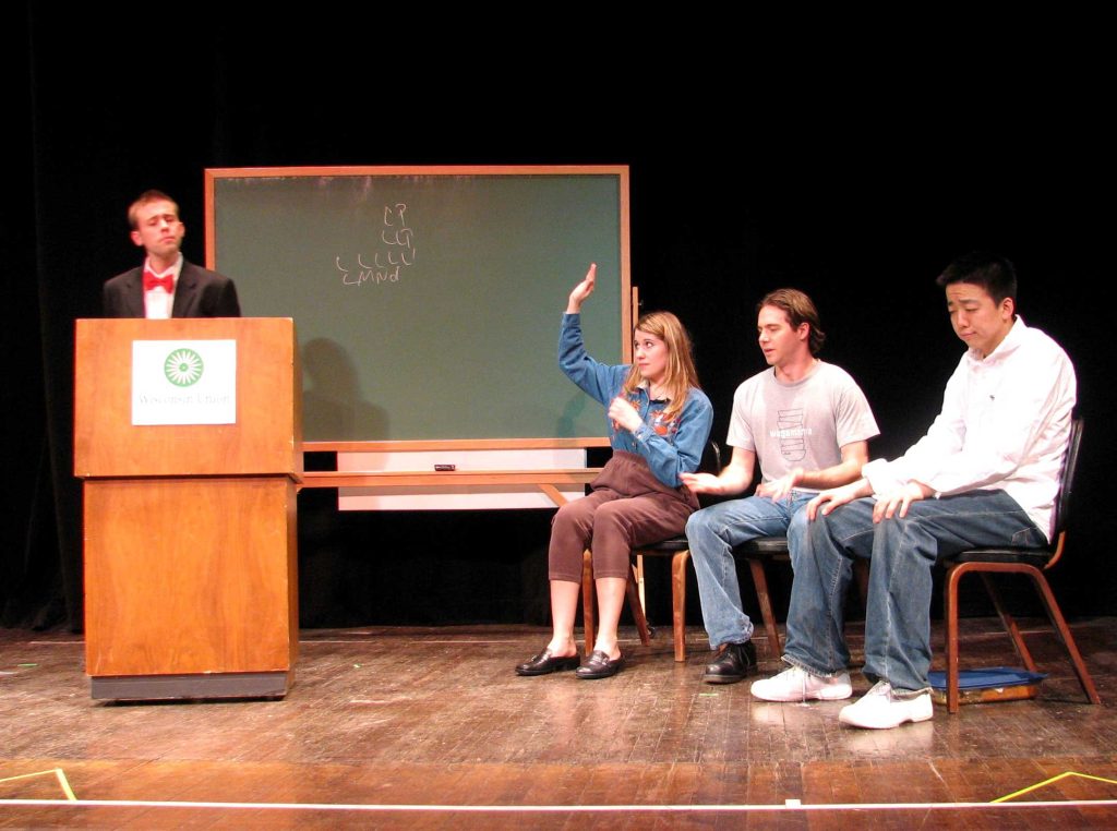 students in a panel on stage