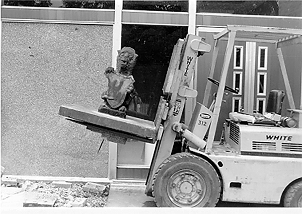 Law School gargoyle on a fork lift, raised into the air