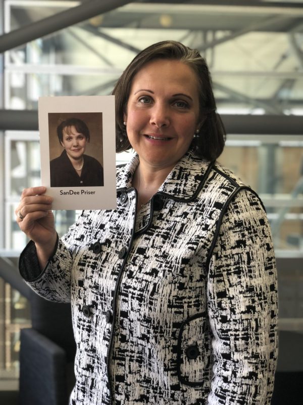 SanDee Priser '02 holds her UW Law graduation photo