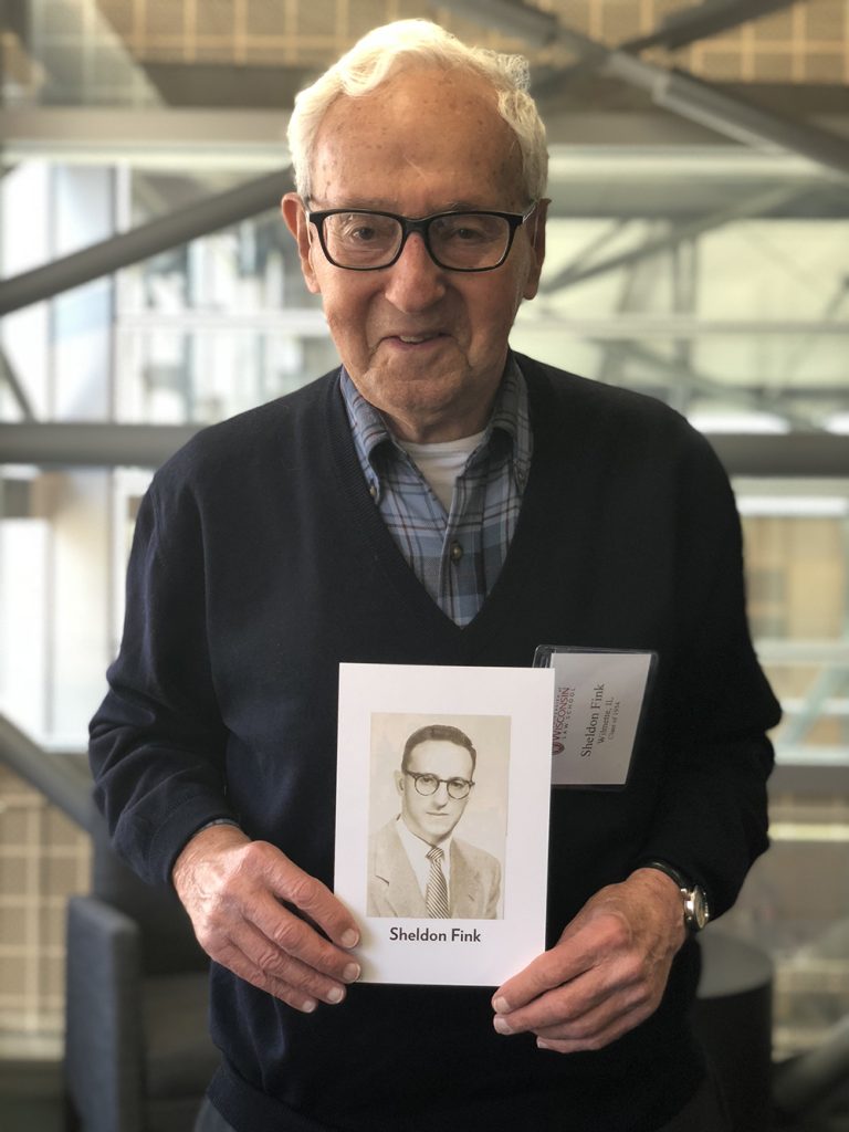 Sheldon Fink '54 holds his class exit photo