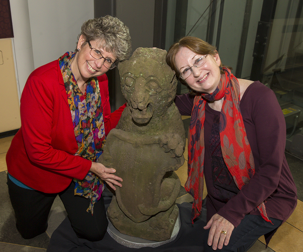 Sisters posing with gargoyle