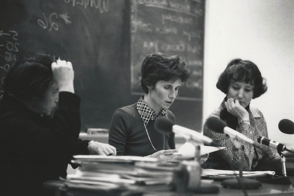 law professionals at desks in front of class