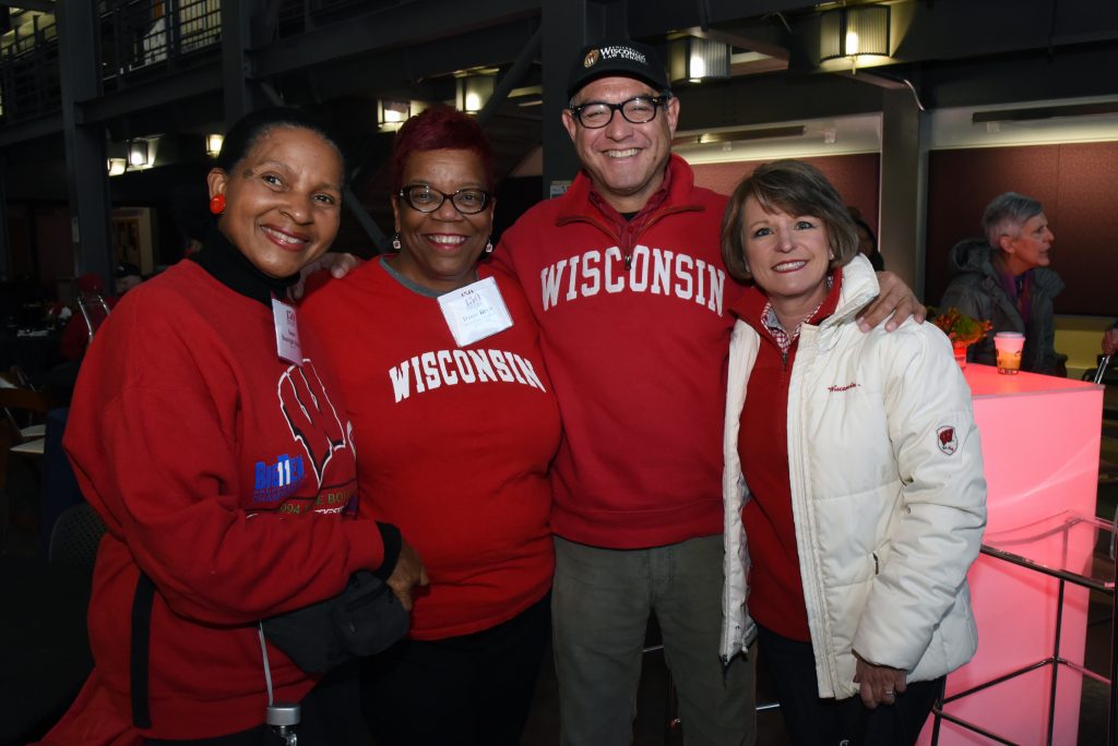 Alumni posing together at tailgate